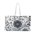 Spacious floral print weekender tote bag with rope handles for travel and beach use.