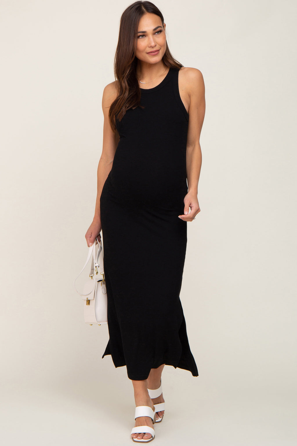 Black ribbed maternity midi dress with side slits, featuring a sleeveless design and comfortable stretch fabric.