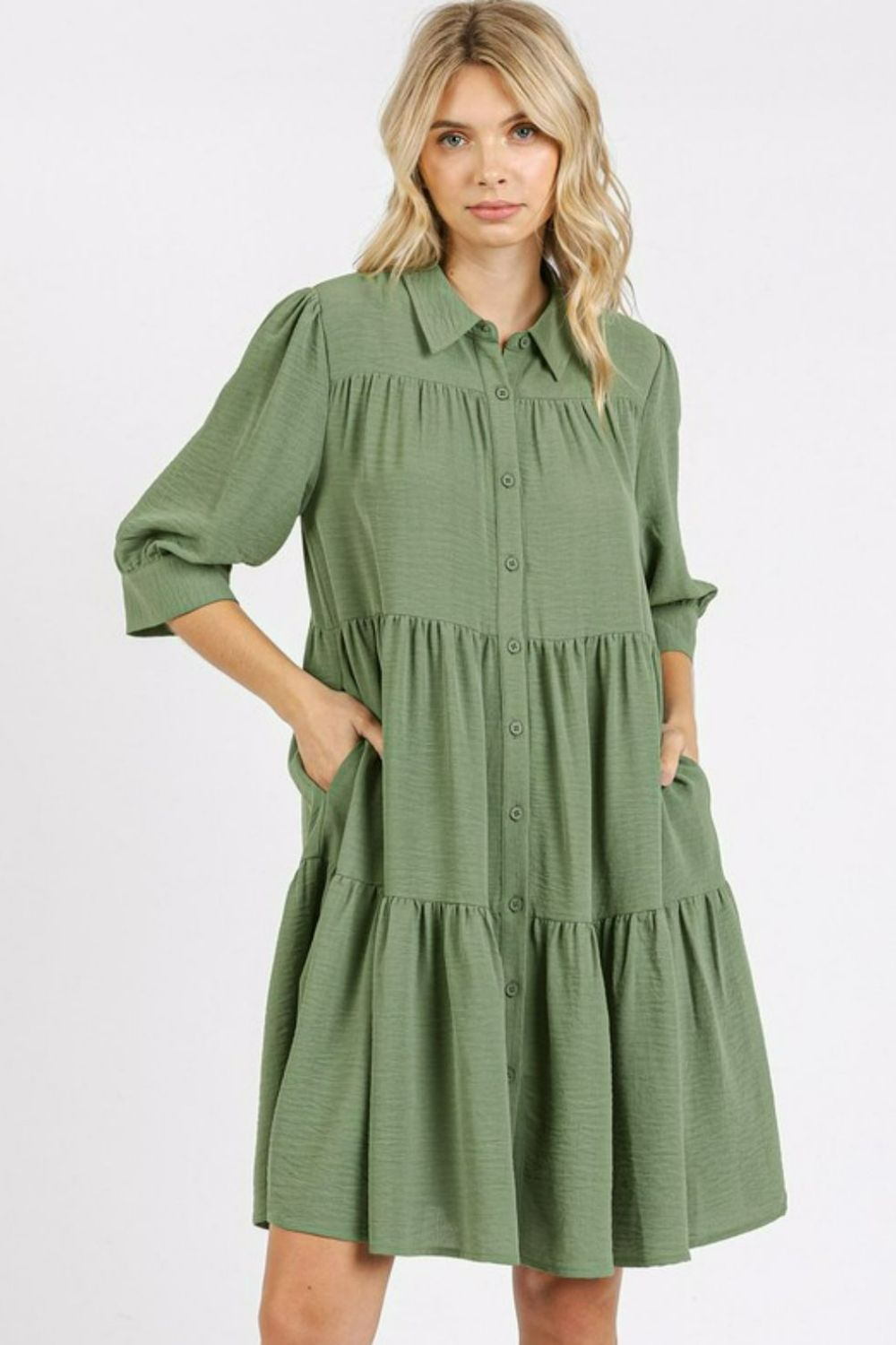 Collared shirt dress featuring a tiered skirt design and elegant button accents.