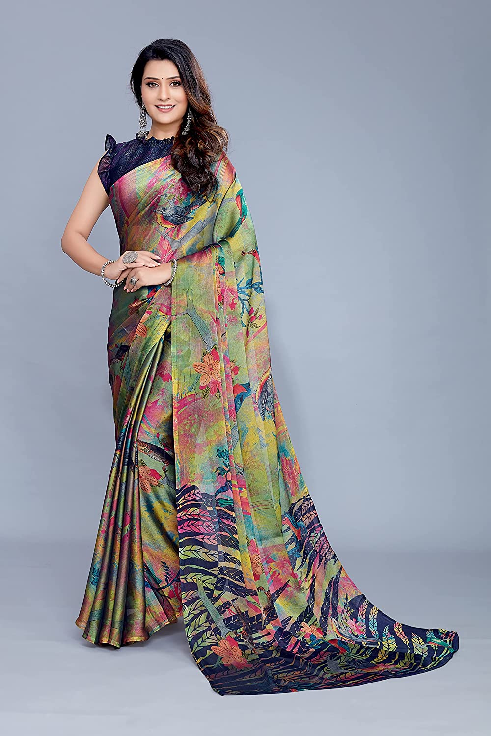 Women wearing a multicolored forest-print chiffon saree with bird floral patterns and a navy blue chevron blouse