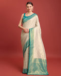 Elegant turquoise Kanjivaram silk saree featuring traditional zari weave.