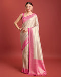 Pink Kanjivaram silk saree with intricate zari woven patterns for festive wear.