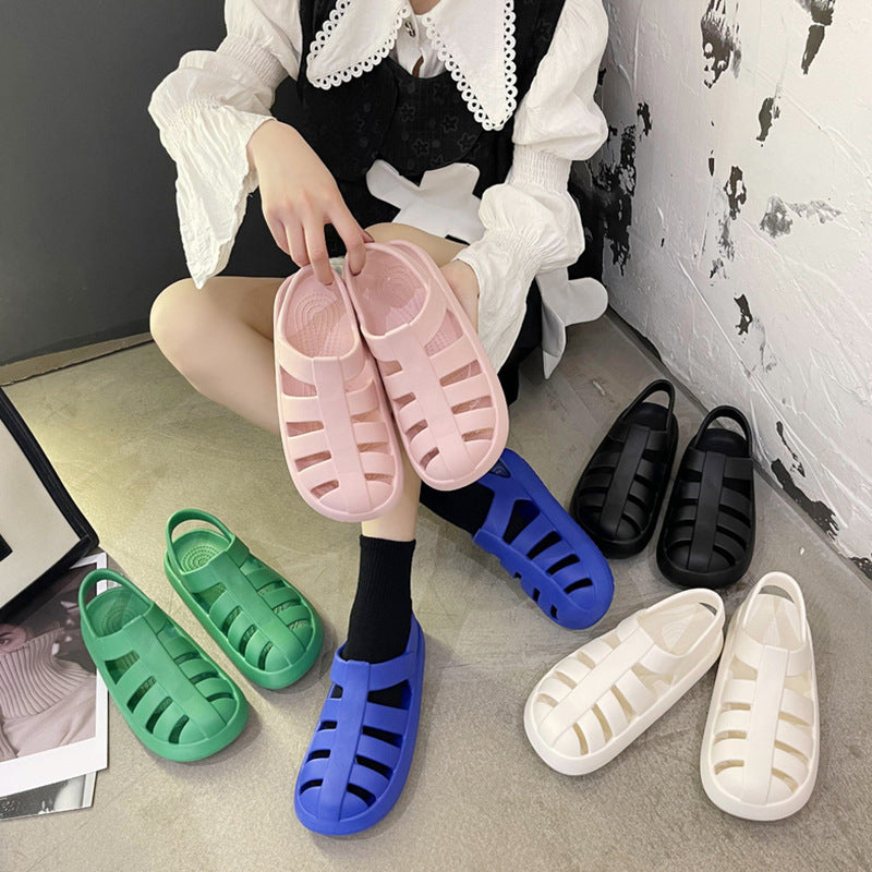 A collection of lightweight Roman-style women's sandals in pink, blue, green, white, and black, displayed for beach and pool wear.