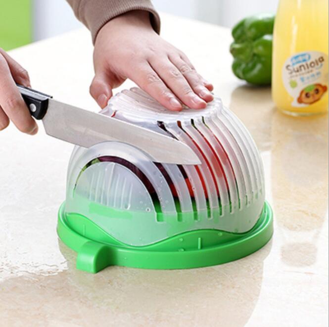 Modern green and white salad cutter bowl with 13 cutting seams on a kitchen countertop