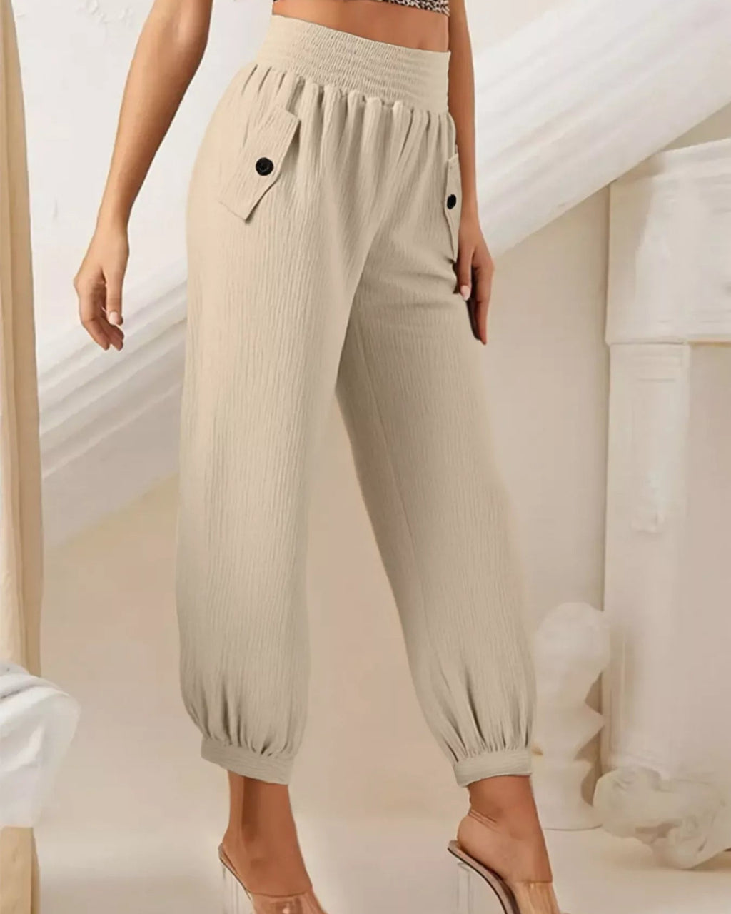 Beige pants worn by a person on a neutral background