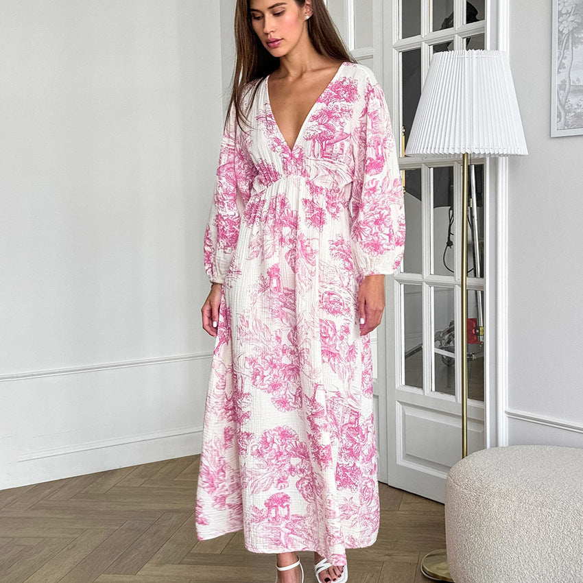 Woman wearing a floral A-line dress with lantern sleeves and V-neck in a soft pink print