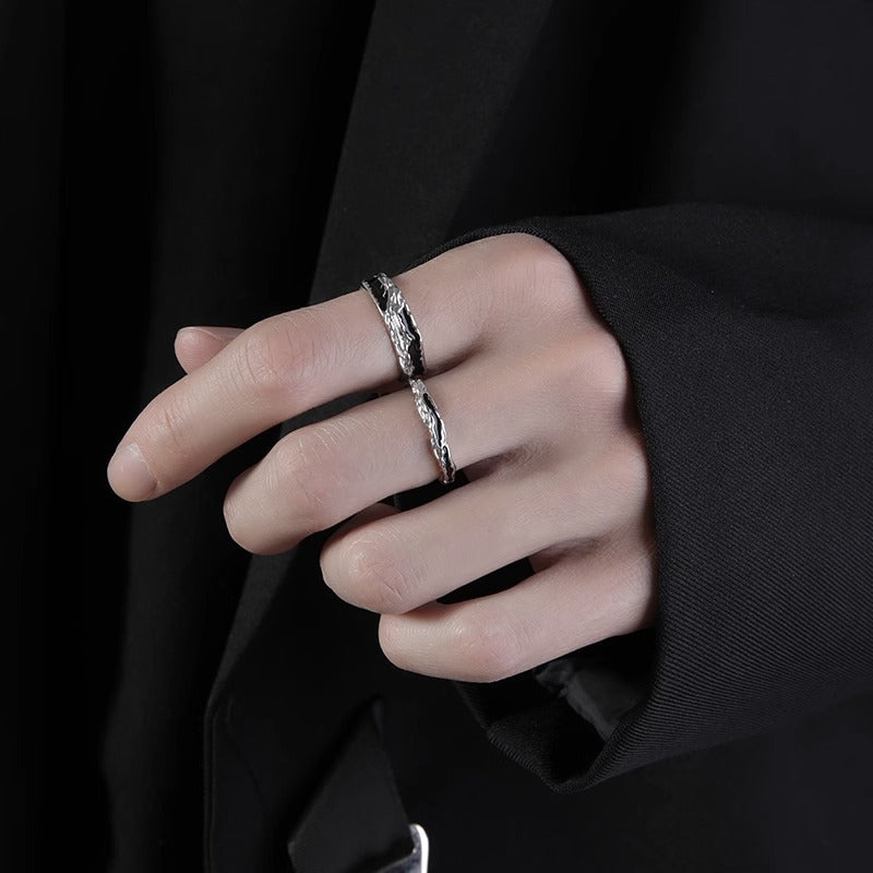 Close-up of a men's adjustable S925 sterling silver ring with textured metal and sleek enamel inlay