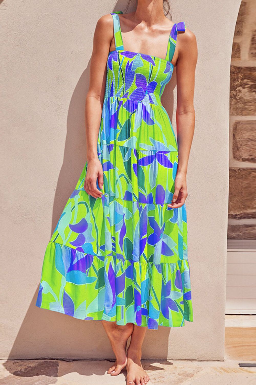 Vibrant floral midi dress with smocked bodice and adjustable tie-shoulders