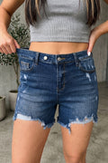 Medium-blue high-waist denim shorts with distressed hems, whiskery patterns, and dual-button waist closure.