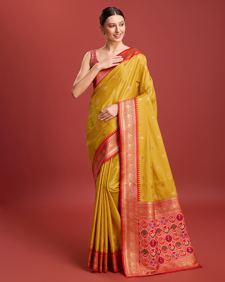 Mustard Banarasi tissue silk saree showcasing a detailed Patola pallu.