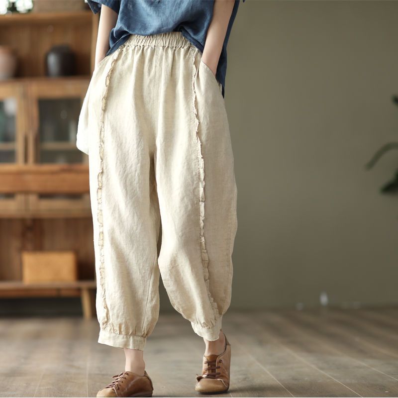 Model wearing high-waist capri harem pants in beige and black with ruffled seam detail