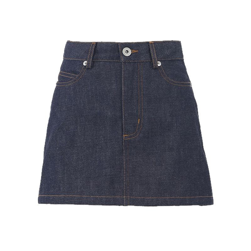 Women's dark wash denim mini skirt with classic five-pocket styling and front button closure, modeled on a street in a casual outfit.