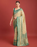 A beige zari woven Banarasi tissue silk saree featuring intricate metallic patterns.