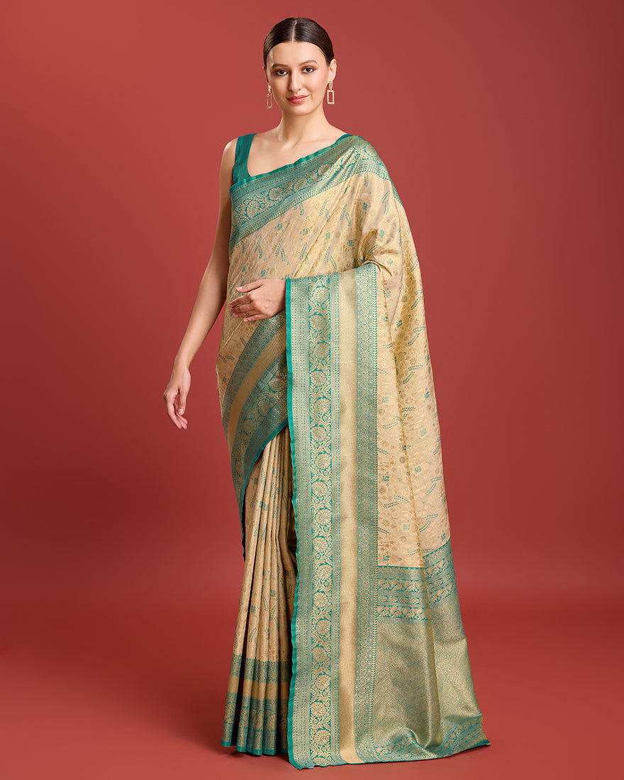 A beige zari woven Banarasi tissue silk saree featuring intricate metallic patterns.
