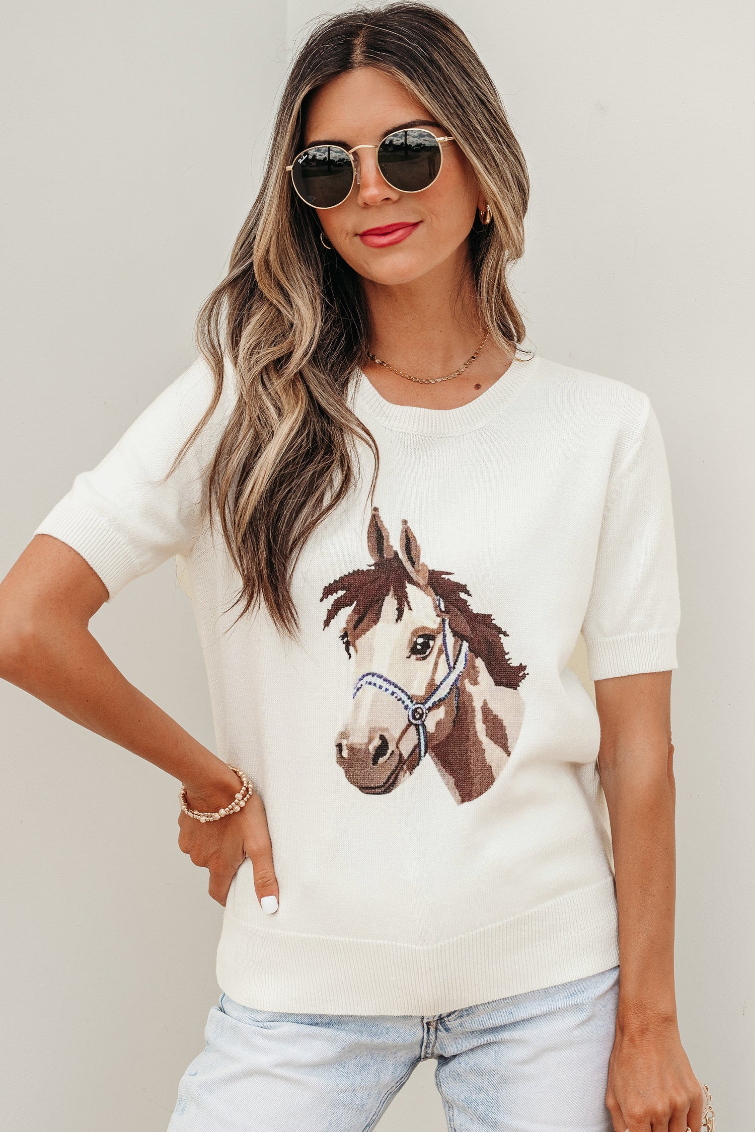 Regina short sleeve crew neck knit sweater in off-white with an embroidered horse graphic