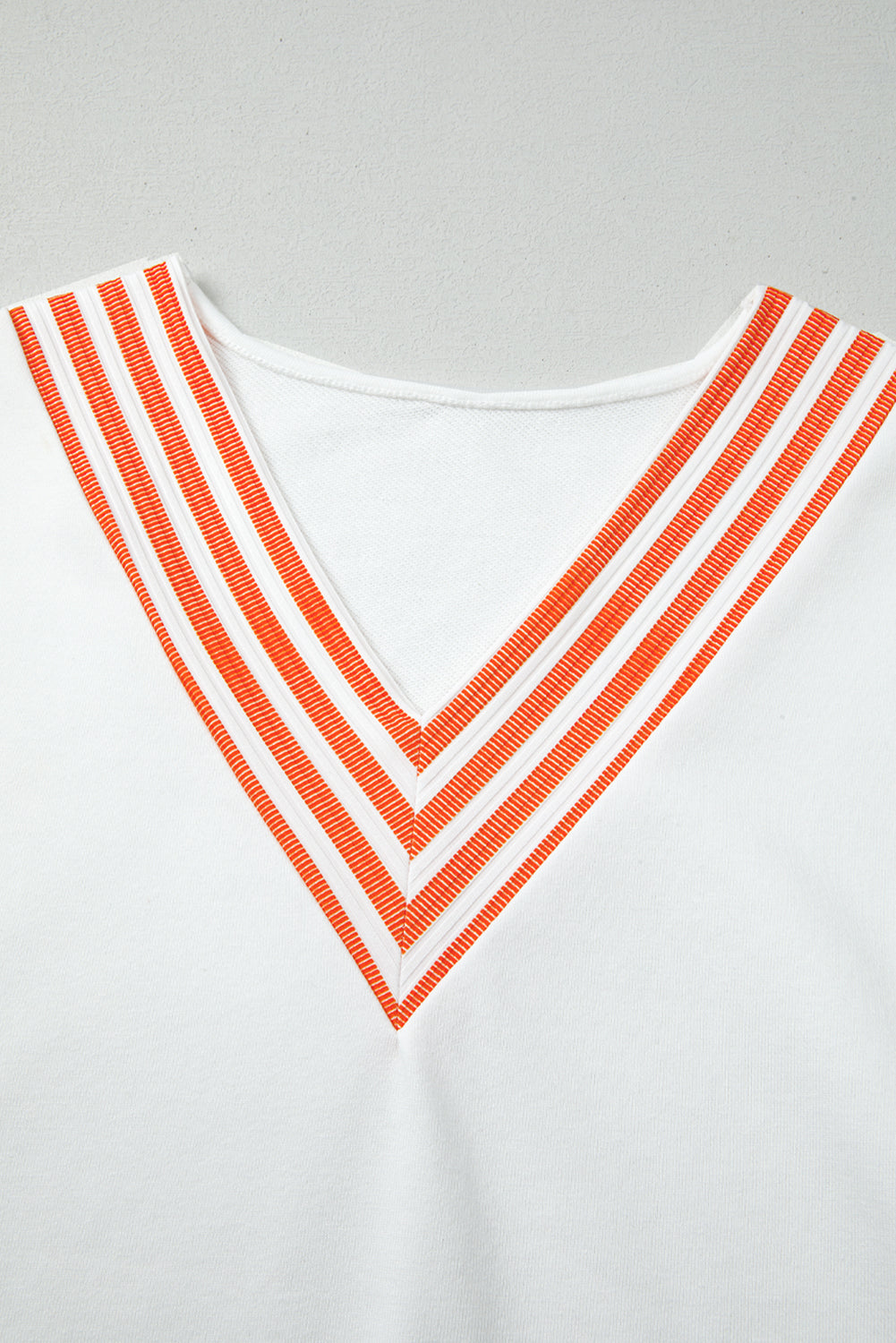 White Long Sleeve Top with Orange Striped Accents and V-Neck
