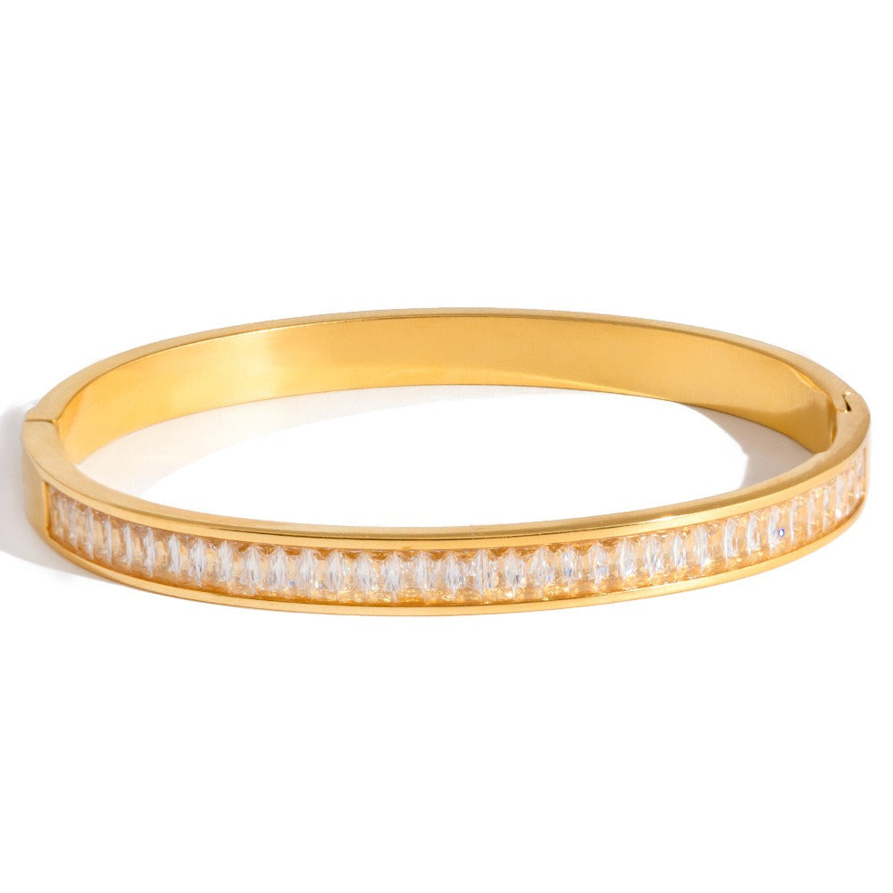 Close-up of a minimalist 18K gold-plated titanium steel bracelet featuring subtle rhinestone accents.