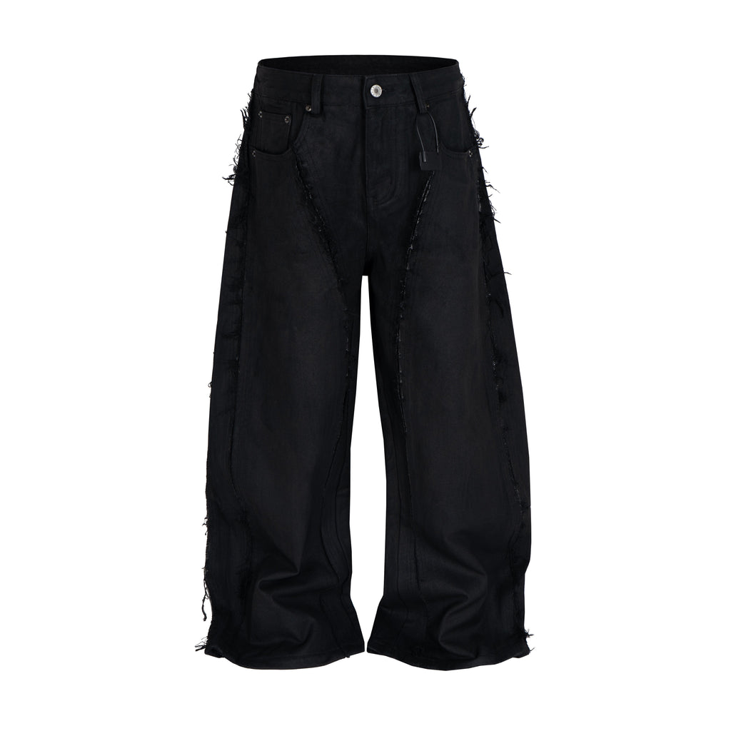 Front view of black waxed baggy jeans with distressed side panels on white background