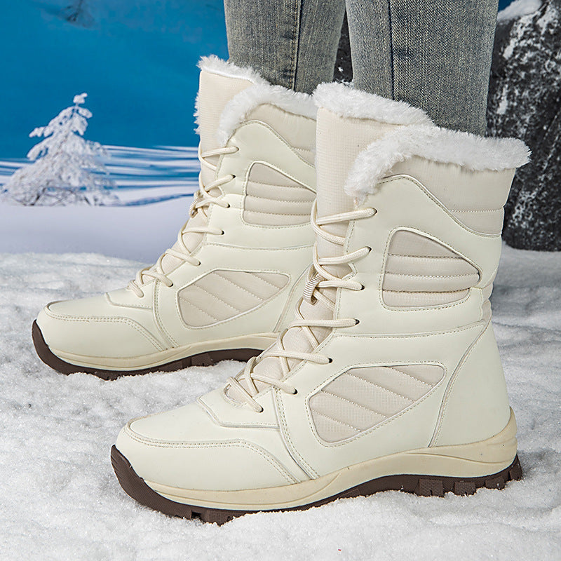 A pair of white and a pair of green high-top waterproof winter snow boots with fleece lining shown in a snowy setting.