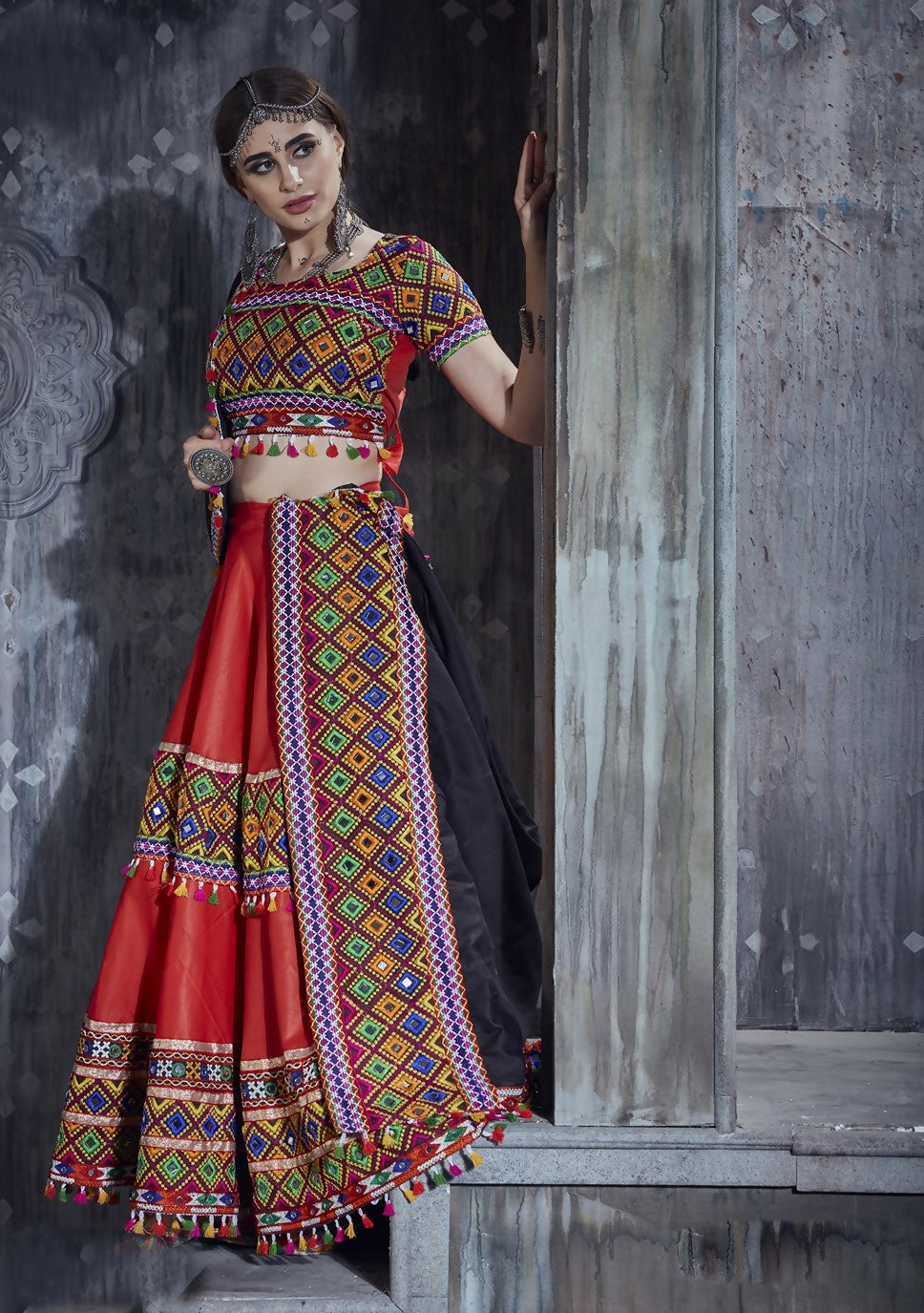 Vibrant red art silk lehenga with a contrasting black dupatta.