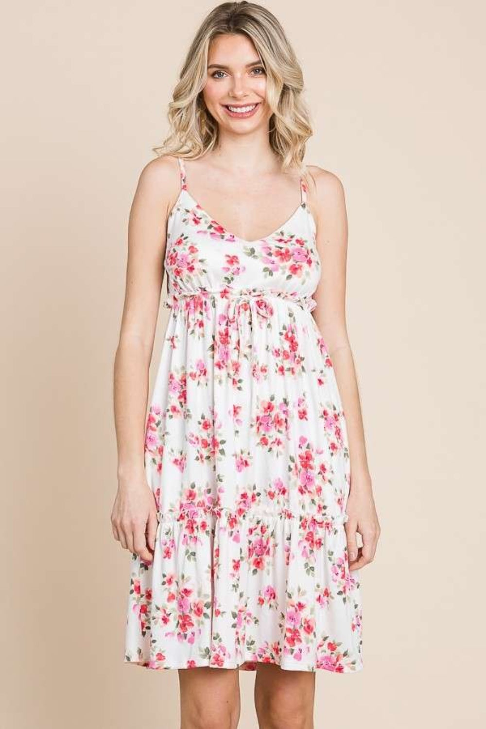 Feminine white and pink floral cami dress with frill accents, perfect for summer.