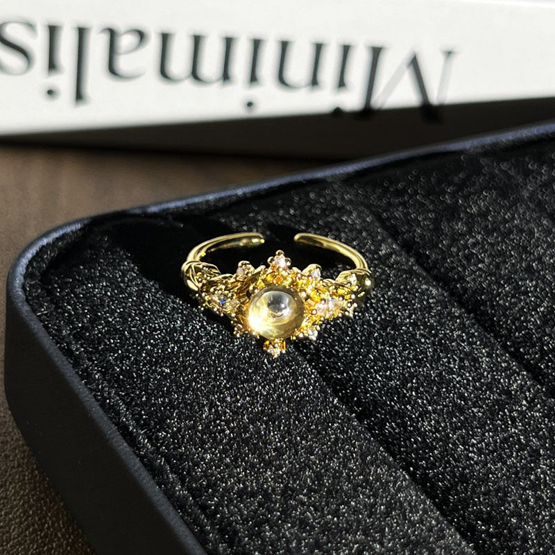 Geometric micro-pave open ring in gold and multicolor finish on a person's hand