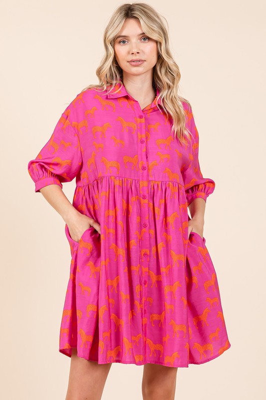 Woman wearing a stylish zebra print button-down shirt mini dress with tiered hem and pockets.