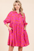 Woman wearing a stylish zebra print button-down shirt mini dress with tiered hem and pockets.
