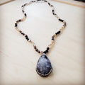 Long black lava bead necklace with a large teardrop shaped druzy pendant and crystal accents