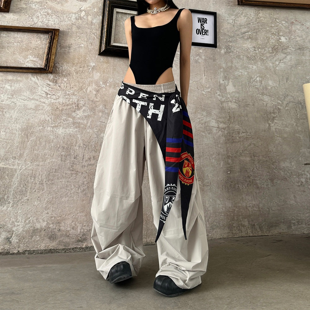 Model wearing women's quick dry loose wide leg pants in beige with a decorative patterned tie. Another image shows the pants in olive green.