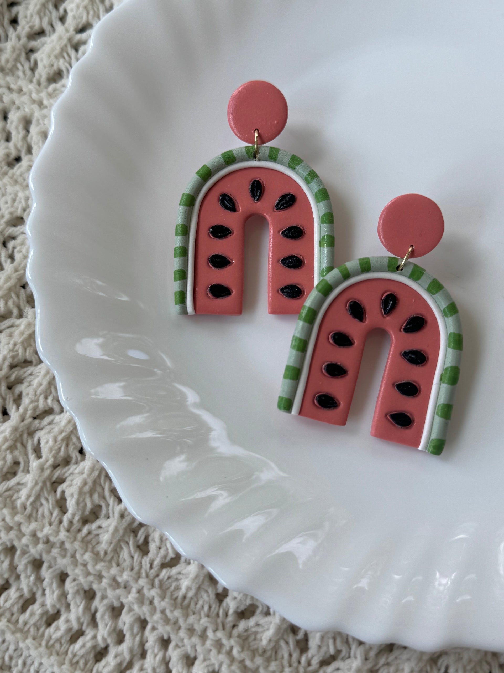 Playful Melony earrings in pink, green, and black polymer clay with gold-plated accents.
