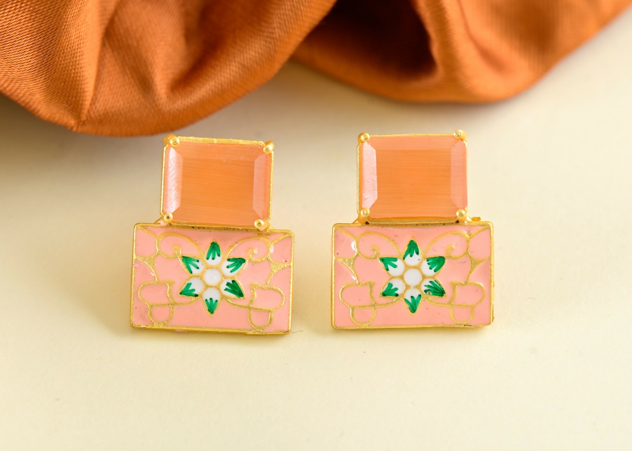 A pair of elegant peach onyx earrings crafted in brass for a sophisticated look.