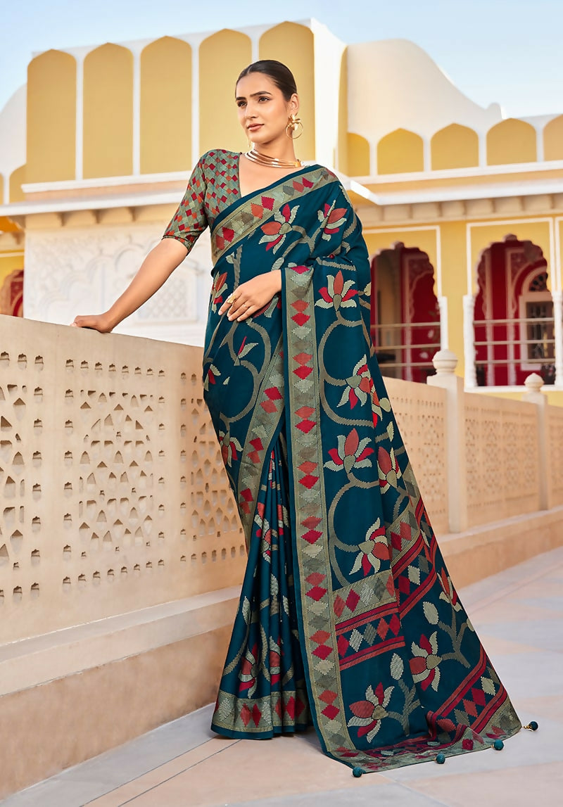 Teal silk blend saree with synchronized printed patterns.