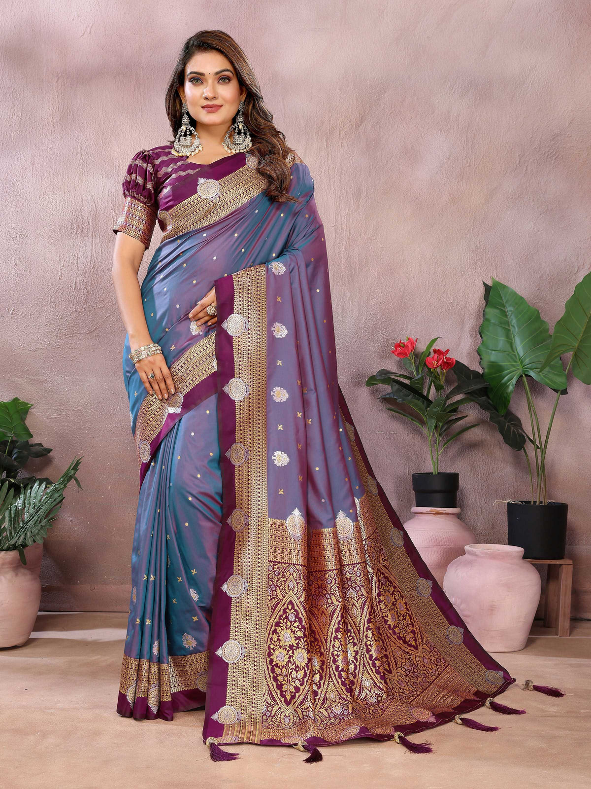 A regal purple silk saree featuring intricate traditional weaving patterns.