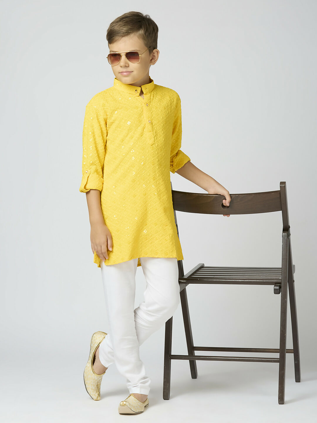 A vibrant yellow cotton kurta and pyjama set for kids with detailed sequin work, perfect for festive occasions.