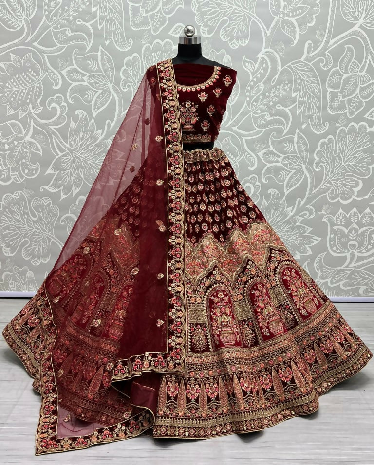 Close up of Maroon Velvet Wedding Lehenga with intricate multi-thread embroidery and zircon diamonds.