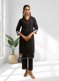 A long black linen kurta with intricate embroidery paired with matching trousers for a festive look.