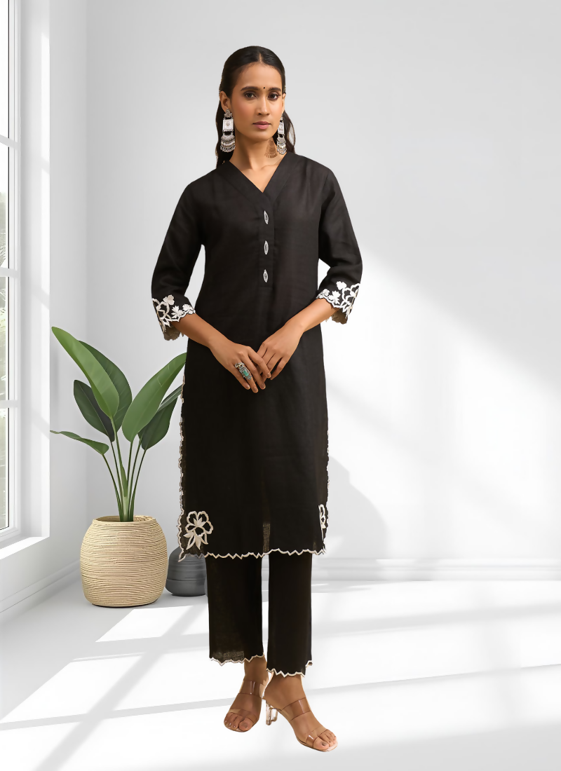 A long black linen kurta with intricate embroidery paired with matching trousers for a festive look.