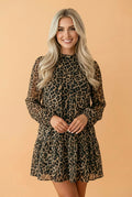 Model wearing a long sleeve leopard print shift mini dress in brown and black with side pockets