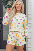 Woman wearing Ember cream knit pullover and matching polka dot drawstring shorts set