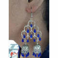 Silver oxidized double Jhumka earrings featuring thick blue pearls