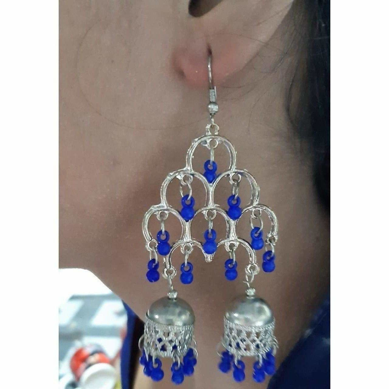 Silver oxidized double Jhumka earrings featuring thick blue pearls