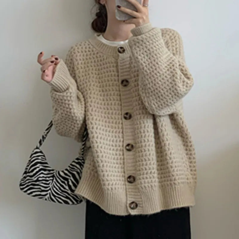 Women wearing a beige and red loose single-breasted knit cardigan with textured pattern