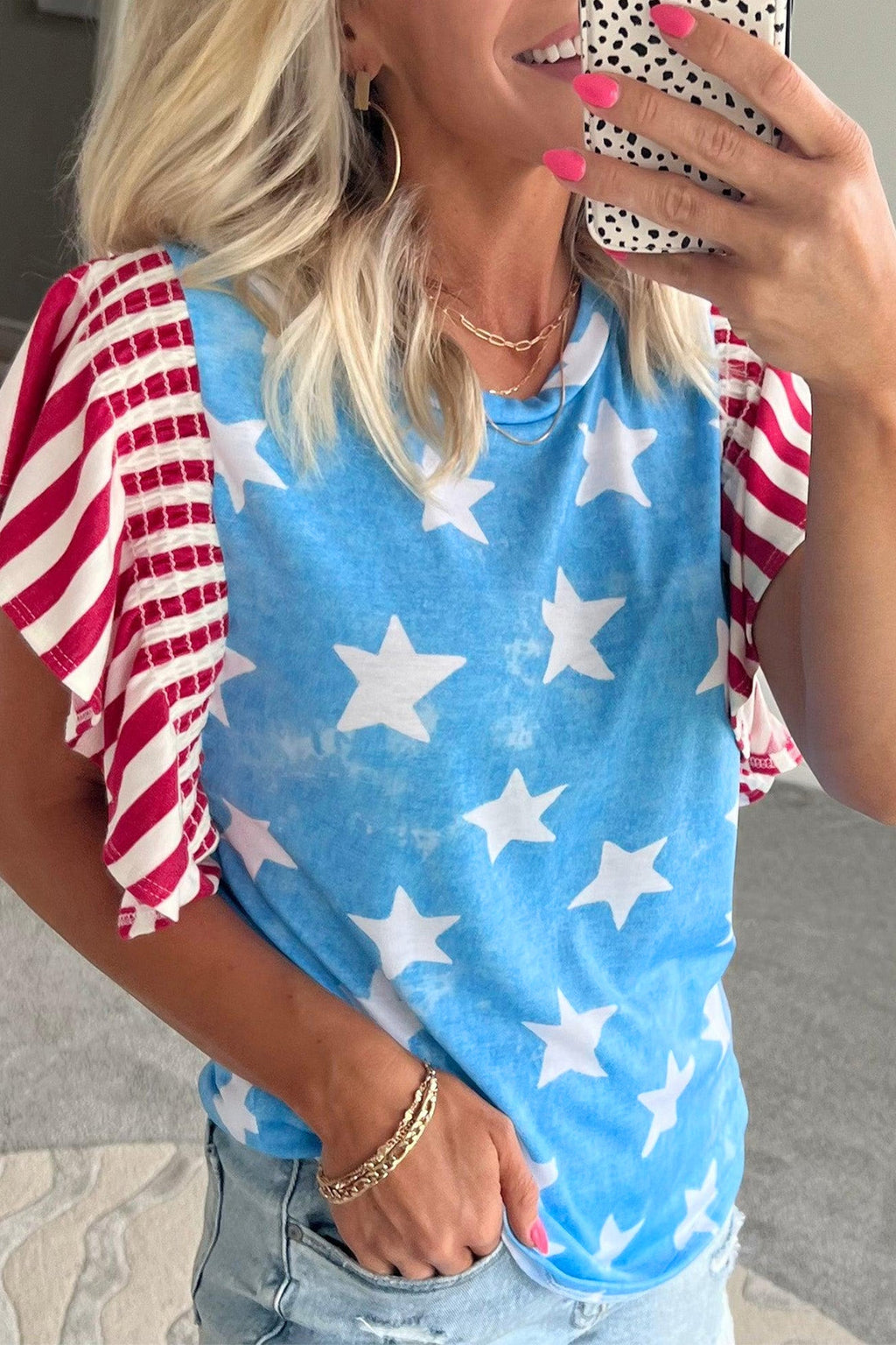 Sky blue sleeveless top with vintage star and stripe pattern and ruffle sleeve details