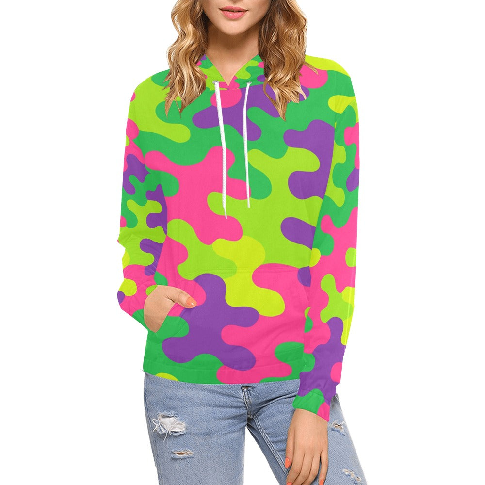Woman wearing a Harajuku rainbow camo print hoodie featuring neon green, hot pink, purple, and lime yellow colors, with a drawstring hood and front pouch pocket.