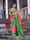 Peach soft silk saree paired with a contrasting green blouse