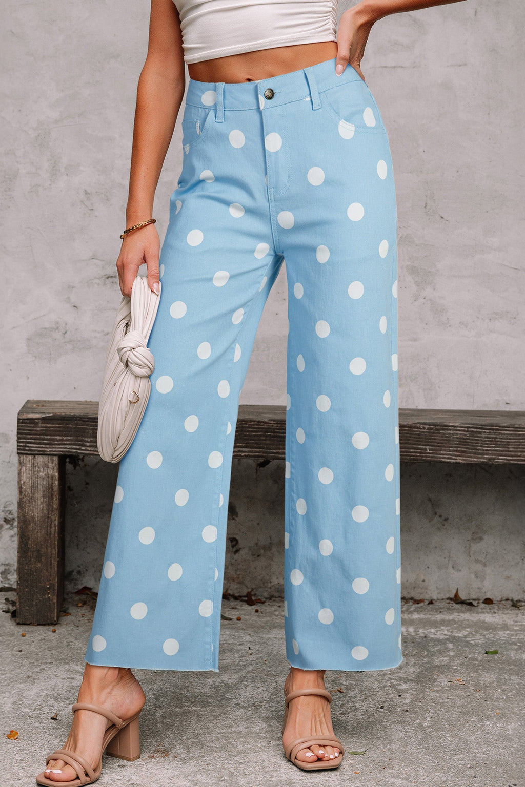 High-waisted light blue and white polka dot shift jeans with a raw hem finish