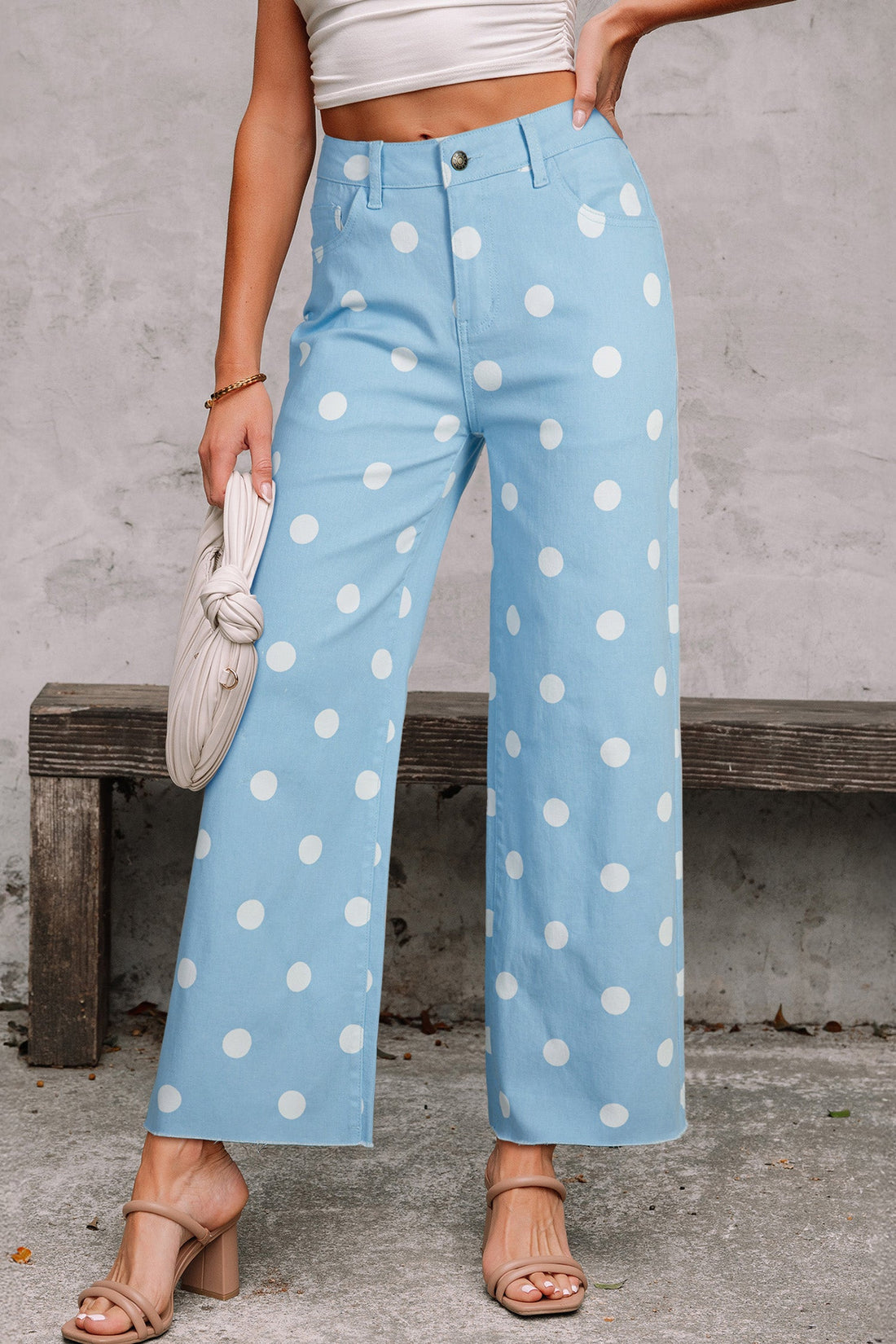 High-waisted light blue and white polka dot shift jeans with a raw hem finish