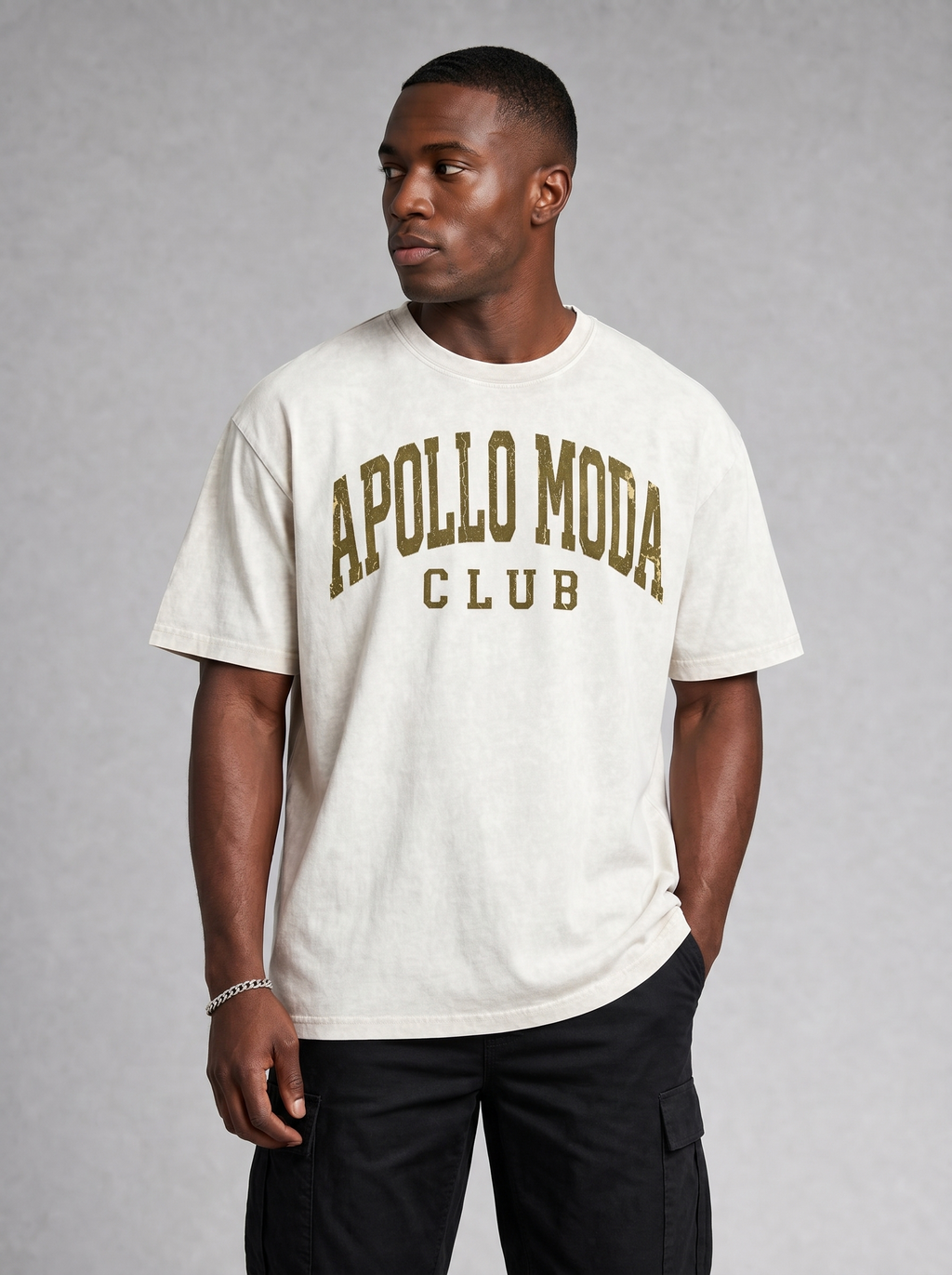 Close-up of collegiate arch graphic in distressed metallic gold on an oversized t-shirt