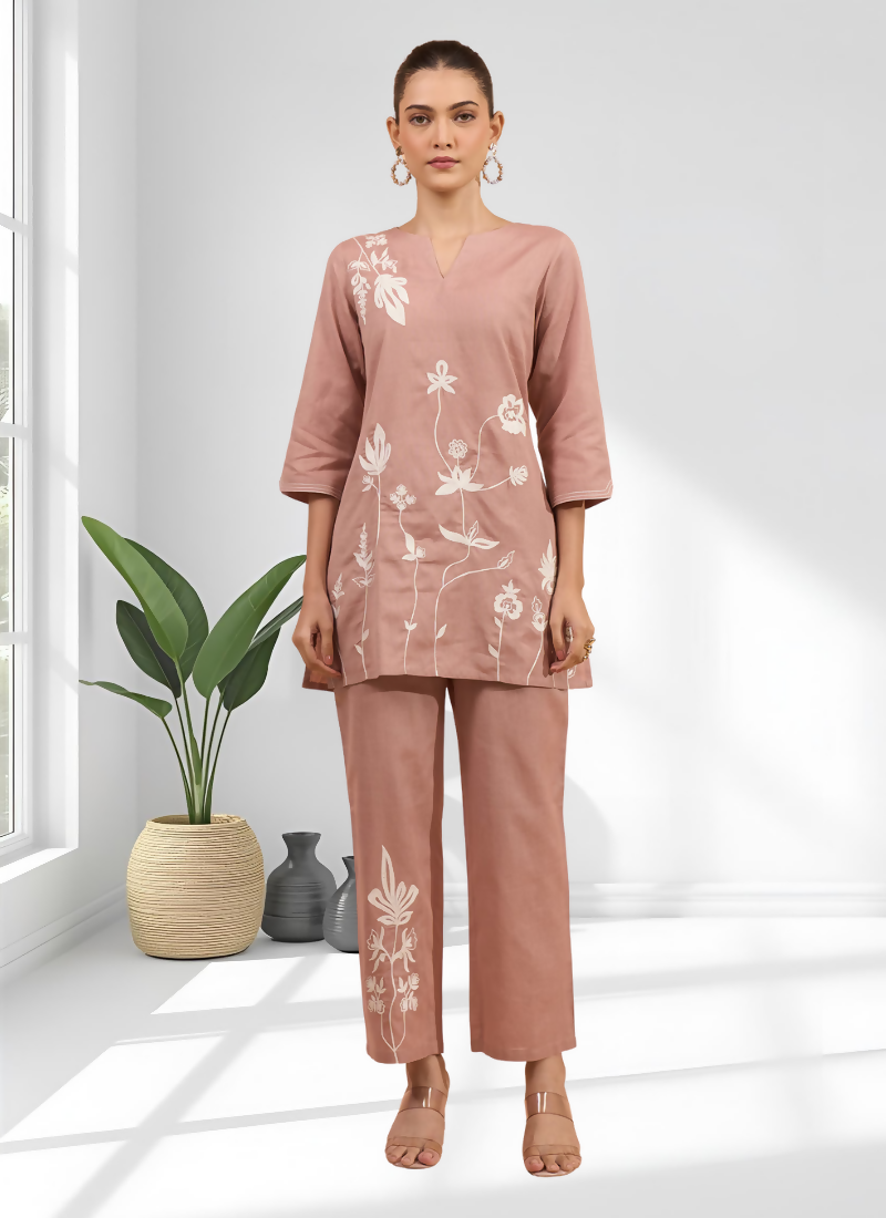 Powder pink cotton and linen cord set featuring delicate embroidery and a V-neckline